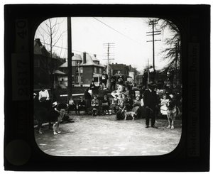 Horizontal, black and white photo of students drawing dogs in an outdoor classroom setting by Unknown